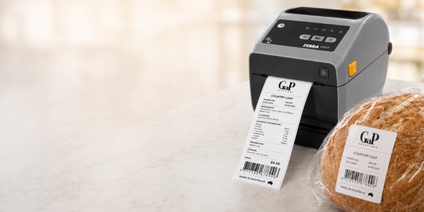 Ezi Labeller printing a bakery label and receipt beside fresh bread