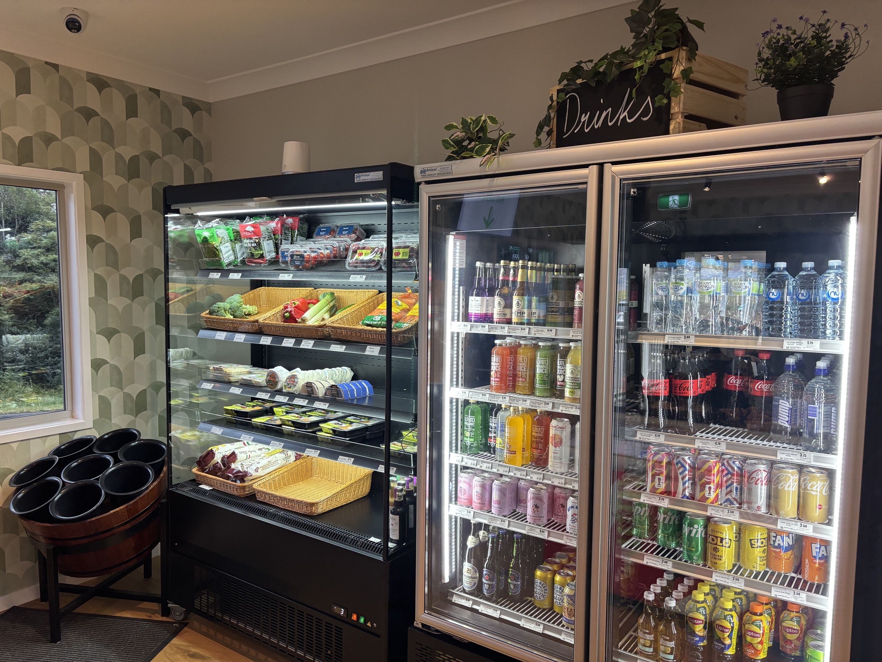 Open-front chiller with salads, wraps and vegetables beside a two-door drinks fridge at Corner Store 24